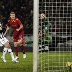 AS Roma's Riise looks on after jumping to score past Juventus' Paolucci and goalkeeper Manninger during their Italian Serie A soccer match in Turi
